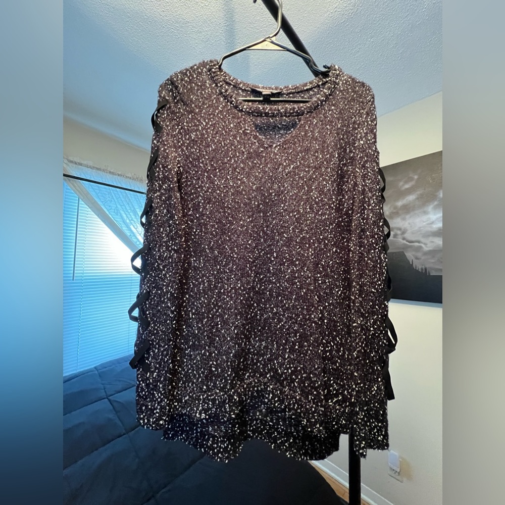 Long sleeve sweater with lace up detail.